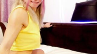 Sarah Luv with pigtails fingers her pussy