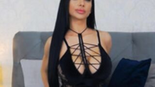 Raisa posing in black lingerie, stockings and heels