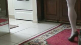 Leggy woman flaunts her muscular legs around the house