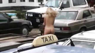 Blonde nude in public in a mechanic area