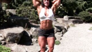 Muscle woman flexes in bra shorts and heels