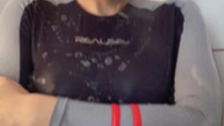 Fit busty angel taking a shower in swimsuit