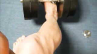 Muscle girl lift weight with feet