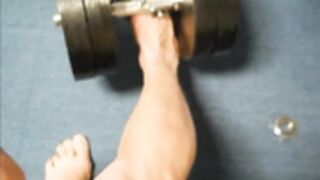 Muscle girl lift weight with feet