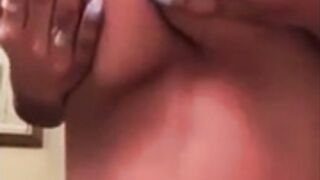 Girl plays with her round tits