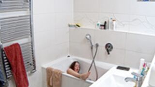 Leora sticks the dildo to the bathtub