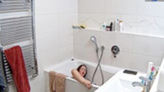Leora sticks the dildo to the bathtub