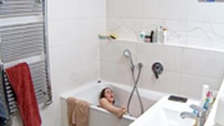 Leora sticks the dildo to the bathtub