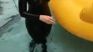 Carrie LaChance in black latex catsuit for a photoshoot