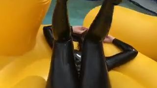 Carrie LaChance in black latex catsuit for a photoshoot