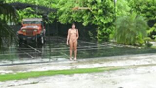 Girl dances in the rain naked