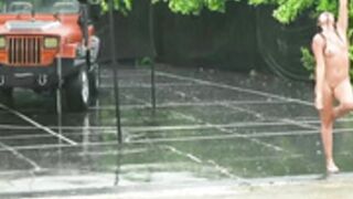 Girl dances in the rain naked