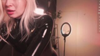 Bronnica in latex and gasmask, slapping her butcheeks.