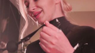 Bronnica in latex and gasmask, slapping her butcheeks.