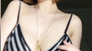 Busty redhead plays with boobs