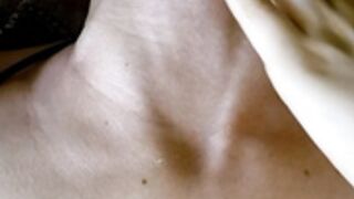 Shows her neck veins while lying down