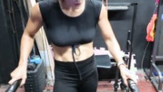 Fitness Latina flexing biceps and armpits sweaty