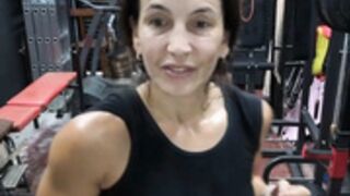 Fitness Latina flexing biceps and armpits sweaty