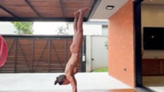 skinny fit muscular mom lr muzzi performs handstand 2