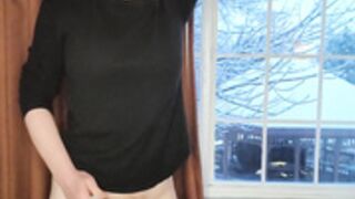 Charlotte stands by a window naked and plays