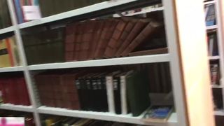 Two blondes making out in the library