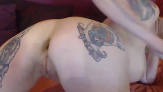 Busty red milf pounds her tattooed ass