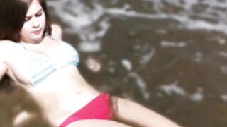 Busty latina brunette tanning by the beach