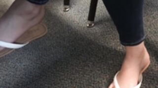Arabic teen dangling flip flops in class
