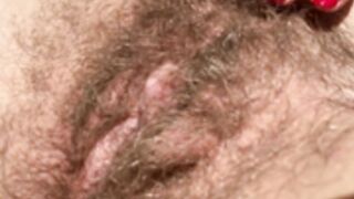 Hairy girl sunbathing outdoor