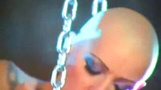 Bald Chick with Snakes, chains and piercings